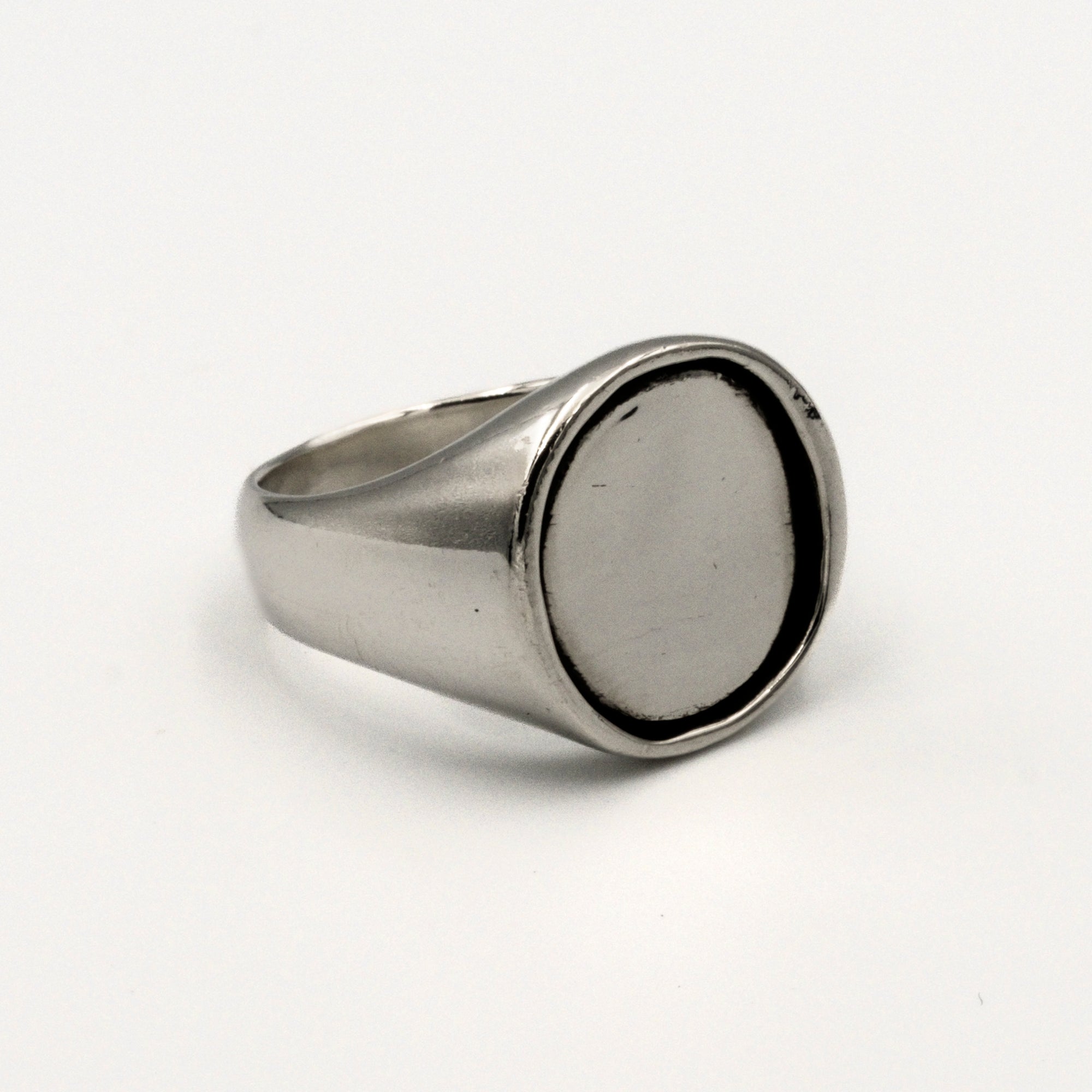 Silver ring with a silver coin inlay on a white background