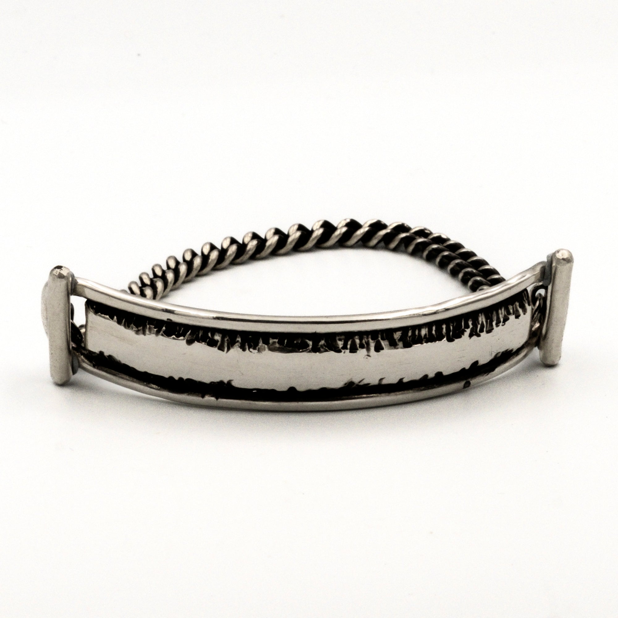 Silver bracelet with a textured band on a white background
