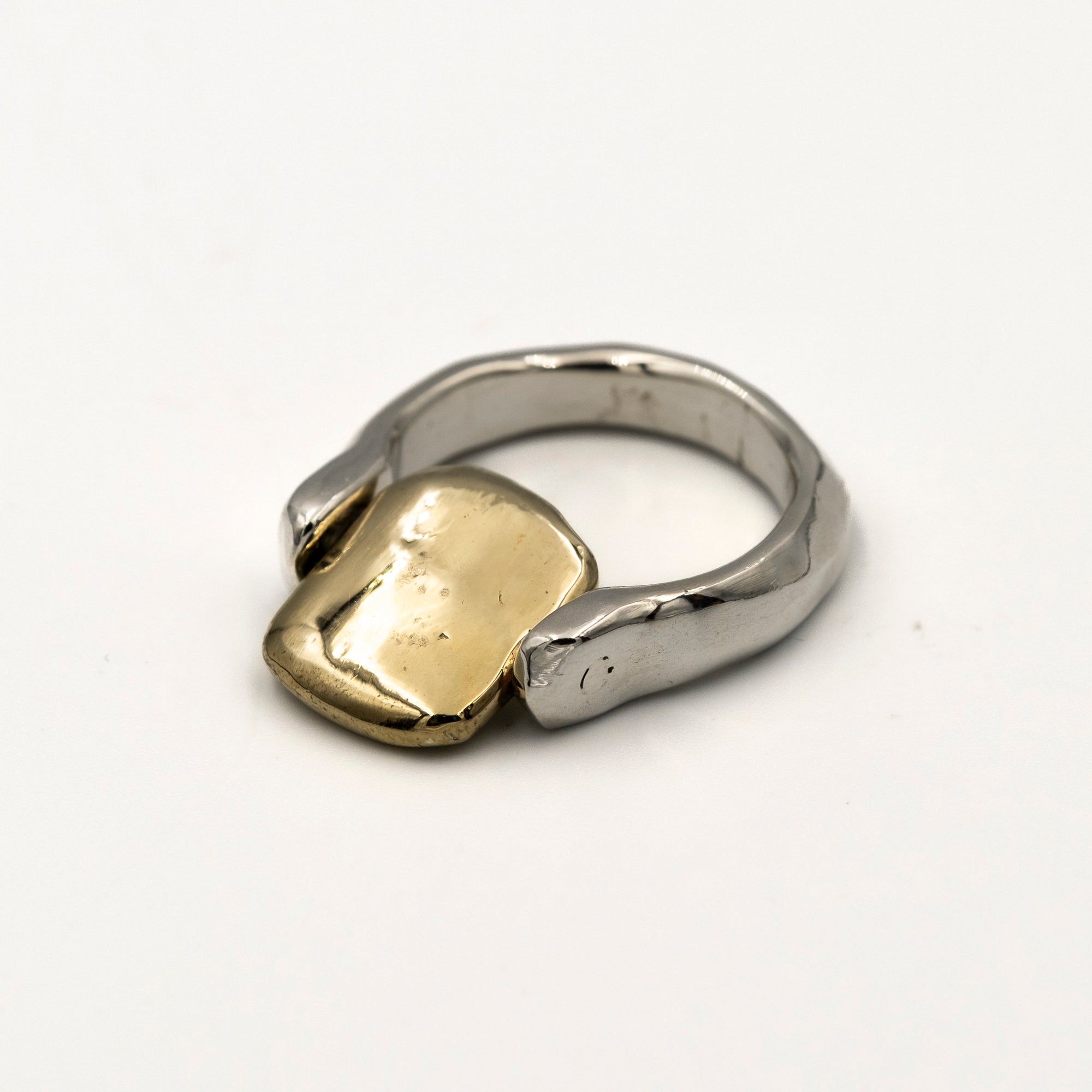 Two-tone ring with gold and silver components on a white background